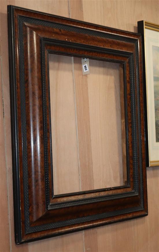 A 19th century Dutch brush grained and ebonised cushion frame wall mirror, W.2ft 7in. H.3ft